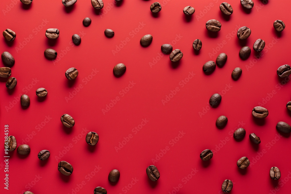 coffee beans seen from above scattered on a red backgr coffee beans seen from above scattered on a red backgr
