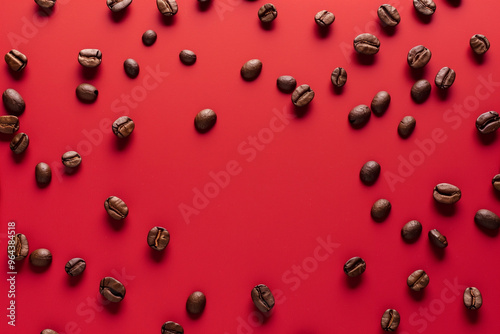 coffee beans seen from above scattered on a red backgr