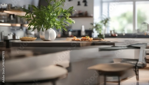 A modern kitchen with a sleek black countertop, a white vase with green leaves, and a plate of food, with a blurred background of a window and a plant.