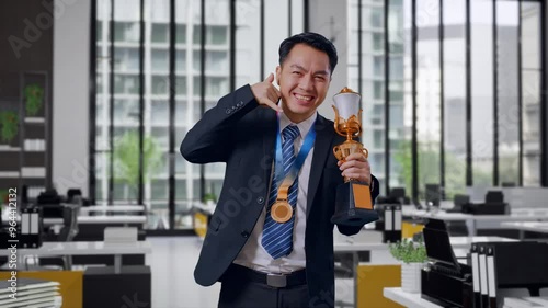 Wallpaper Mural Asian Business Man In A Suit And Tie With A Gold Medal And Trophy Showing Call Me Gesture And Smiling To Camera As The First Winner In Office Torontodigital.ca