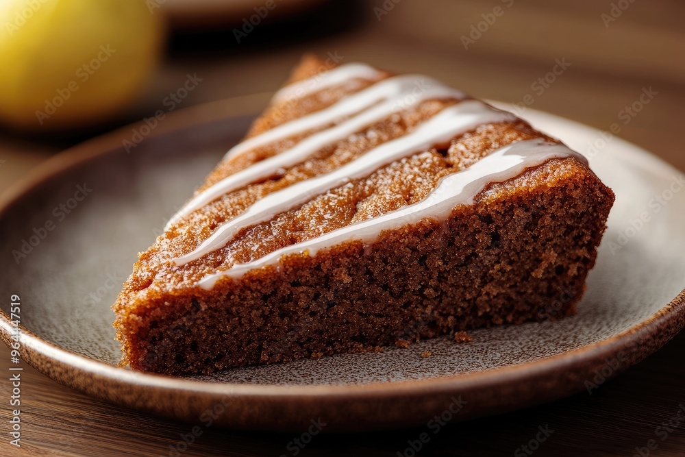 A slice of moist spiced gingerbread drizzled with a tangy lemon glaze, set on a rustic plate A slice of moist spiced gingerbread drizzled with a tangy lemon glaze, set on a rustic plate