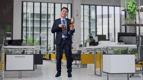 Wallpaper Mural Full Body Of Asian Business Man In A Suit And Tie With A Gold Medal Pointing To A Gold Trophy In His Hand Being Proud Winning As The First Winner In Office Torontodigital.ca