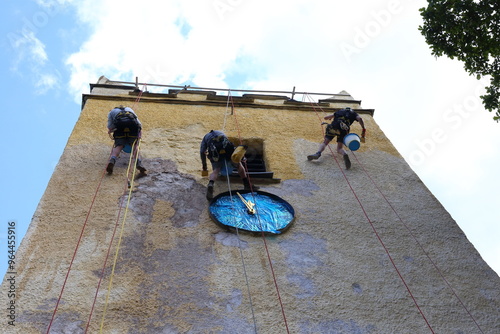 Картината върху платно Abseil whilst you paint! Church clock tower/bell tower needs a new coat of paint