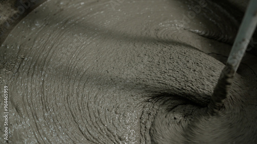 Bild auf Leinwand Construction worker mixing cement at building site.