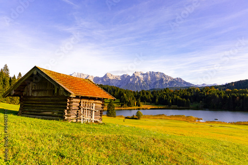 Panoramic view on Geroldsee with traditional mountain huts and the Karwendel in autumn