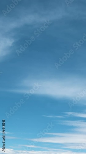 Aerial background of beautiful clouds moving across blue sky in slow motion
