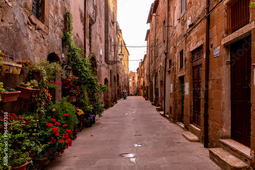 Narrow street with historic medieval houses in Pitigliano Tuscany