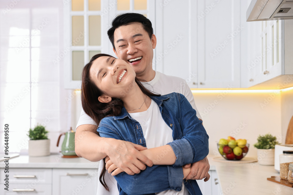 Lovely couple enjoying time together in kitchen Lovely couple enjoying time together in kitchen