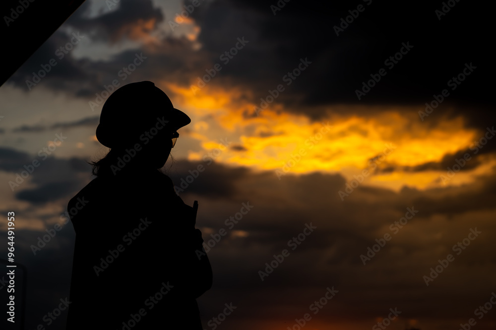 Silhouette of young asian female engineer on sunset Silhouette of young asian female engineer on sunset