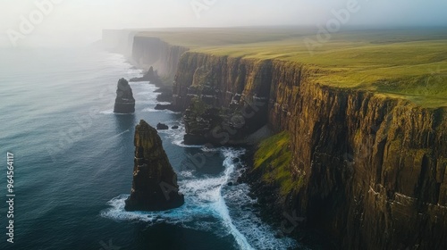 Aerial view of the dramatic cliffs and sea stacks at Trllkonufingur, with the ocean stretching out beyond. photo