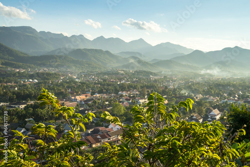 Panoramic View of Luang Prabang Countryside from Mount Phousi in the Late Afternoon – A Stunning Vista of Lush Countryside, Majestic Mountains, and Traditional Lao Architecture in Northern Laos photo