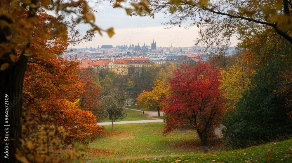 Obraz premium Prague's Letn Park during autumn, with colorful foliage framing views of the city.