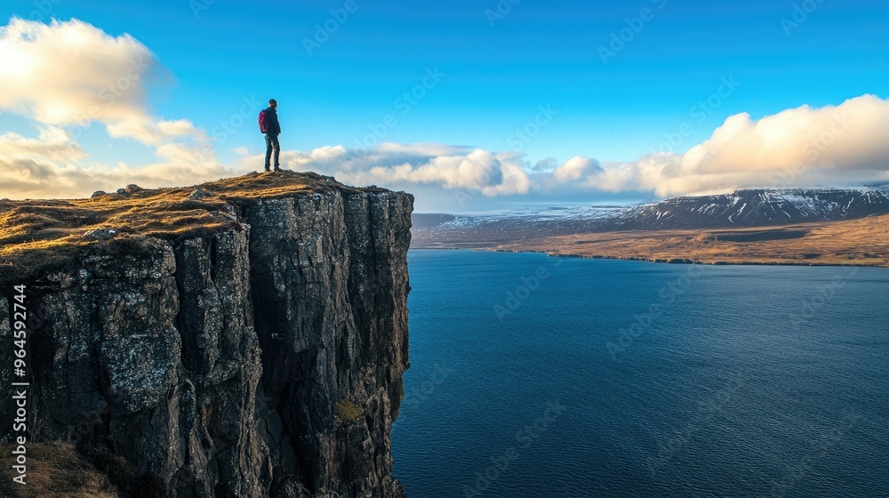 The iconic view of the Sgsvatn lake, perched above the ocean on the island of The iconic view of the Sgsvatn lake, perched above the ocean on the island of