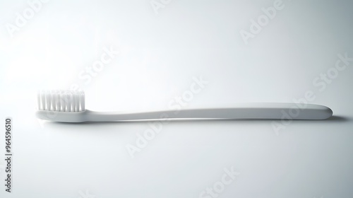 Simple Toothbrush: A plain, white toothbrush with a minimalist design, lying flat on a white background, with a soft shadow beneath it. 