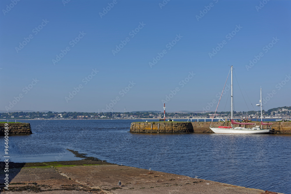 Tayport Harbour Entrance on the south side of the Firth of Tay at High Tide on a bright September Afternoon. Broughty Ferry and Dundee in the distance. Tayport Harbour Entrance on the south side of the Firth of Tay at High Tide on a bright September Afternoon. Broughty Ferry and Dundee in the distance.
