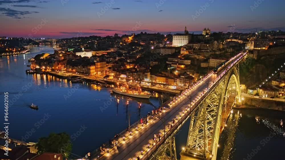 View of illuminated Porto city and Douro river and Dom Luis bridge I from famous tourist viewpoint Miradouro da Serra do Pilar in evening twilight with metro tram. Porto, Vila Nova de Gaia, Portugal View of illuminated Porto city and Douro river and Dom Luis bridge I from famous tourist viewpoint Miradouro da Serra do Pilar in evening twilight with metro tram. Porto, Vila Nova de Gaia, Portugal