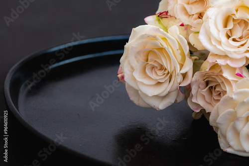 Beautiful pale rose flowers on the black background closeup. Romance, luxury, elegance, sadness , mock up.