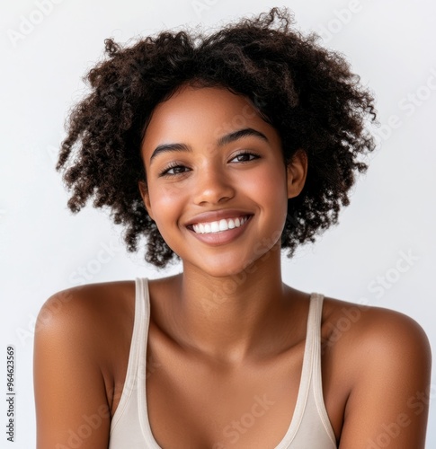 a Black African woman with natural, curly hair and a broad smile. This image emphasizes her poised demeanor and confidence, perfect for business or branding purposes.