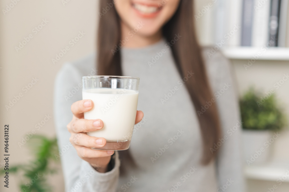 Health care asian young woman, girl holding a glass of white fresh, dairy soy milk to drink for calcium, vitamin wholesome good nutrition in the morning at kitchen home, product of healthy people. Health care asian young woman, girl holding a glass of white fresh, dairy soy milk to drink for calcium, vitamin wholesome good nutrition in the morning at kitchen home, product of healthy people.