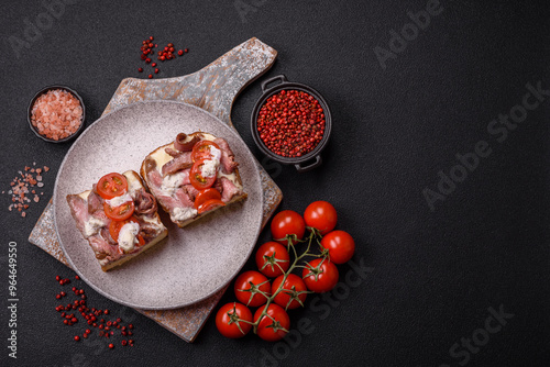 Sandwich with brioche bun, roast beef, tomatoes, stracciatello photo