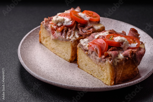 Sandwich with brioche bun, roast beef, tomatoes, stracciatello photo