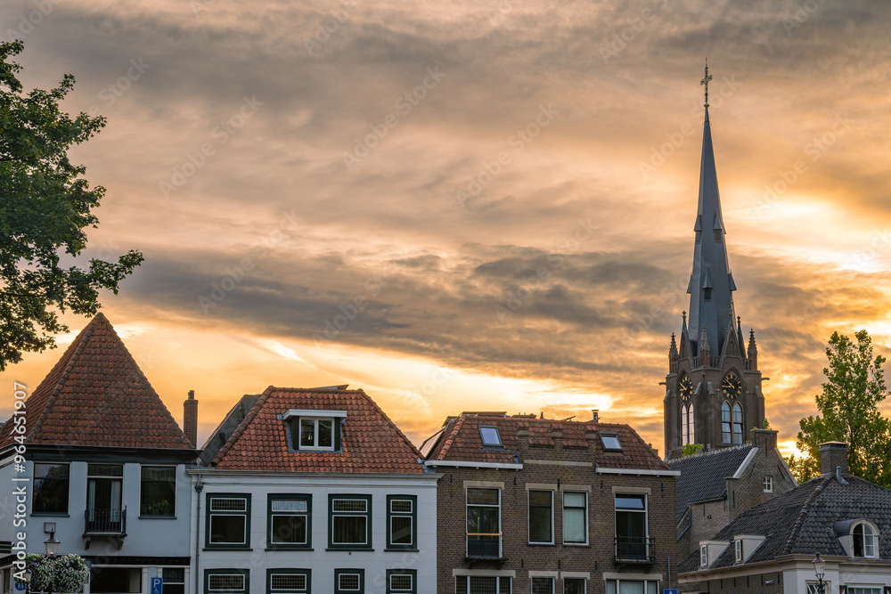 Fototapeta premium Skyline of Weesp, North Holland, The Netherlands. View of the St. Laurentius church and historical houses by sunset