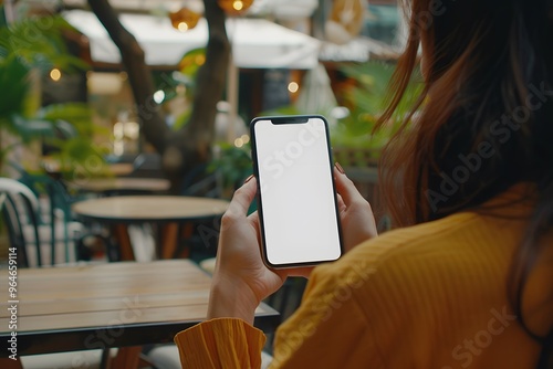 Mockup image of a beautiful woman pointing finger at a mobile phone with blank white screen