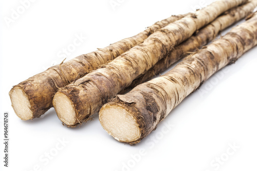 Three burdock roots lying on a white background, ready to be used for their medicinal properties