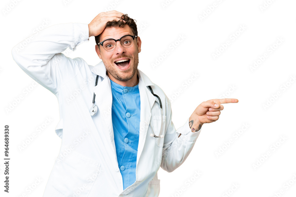 Brazilian doctor man over isolated chroma key background surprised and pointing finger to the side Brazilian doctor man over isolated chroma key background surprised and pointing finger to the side