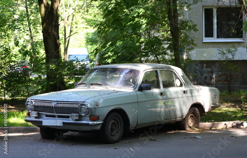 An old rusty Soviet car at the entrance of a residential building, Tovarischeskiy Prospekt, Saint Petersburg, Russia, June 27, 2024