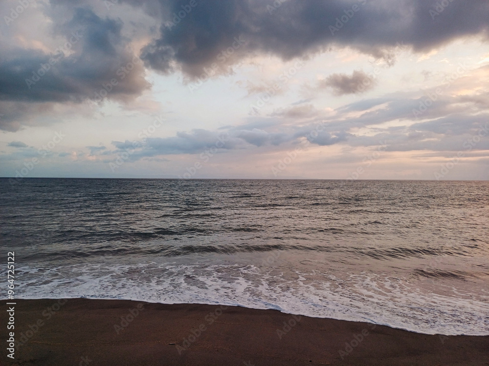 Waves crashing on a beach at sunset Waves crashing on a beach at sunset