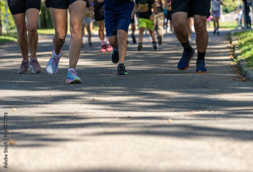 Feet of marathon runners. Runners on the street. Healthy lifestyle. Feet of marathon runners. Runners on the street. Healthy lifestyle.