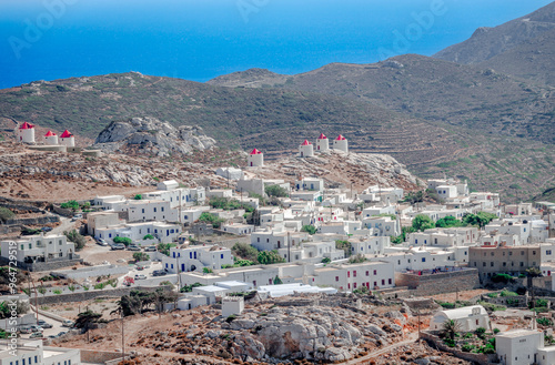 Panorama of Chora of Amorgos, a mountainous village located in the center of the island, overlooking the Aegean Sea. Whitewashed houses and windmills on top of the mountain. Cyclades Islands, Greece.