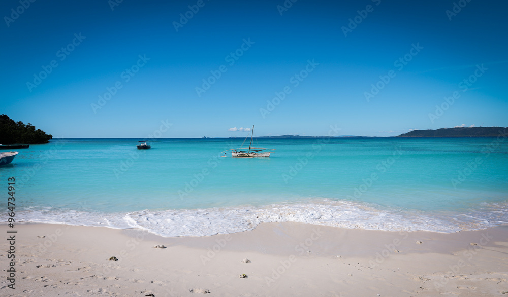 Stunning Paradise Beach in Nosy Be showcasing clear turquoise waters and tranquil sandy shores Stunning Paradise Beach in Nosy Be showcasing clear turquoise waters and tranquil sandy shores