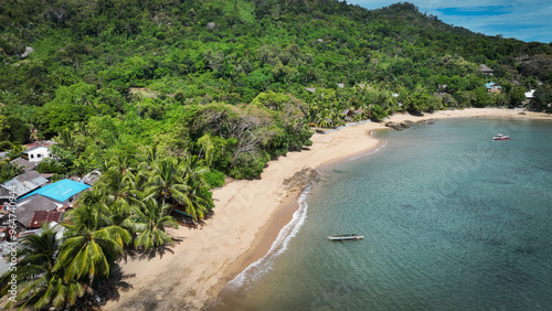 Aerial view of Nosy Komba Island in Madagascar showcasing its lush greenery and tranquil beach along the coastline photo