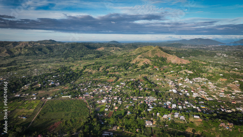 Aerial view of lush greenery and hills on Nosy Be Island in Madagascar showcasing the natural beauty and local settlements