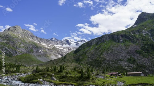 Zoom in timelaps sowing the mountains near the city ginzling located in the Austria Alps, clouds passing by, mountains partly covered in snow