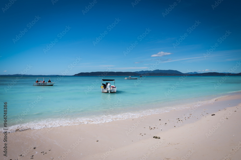 Relaxing boats at Nosy Iranja Island in Madagascar under a clear blue sky Relaxing boats at Nosy Iranja Island in Madagascar under a clear blue sky