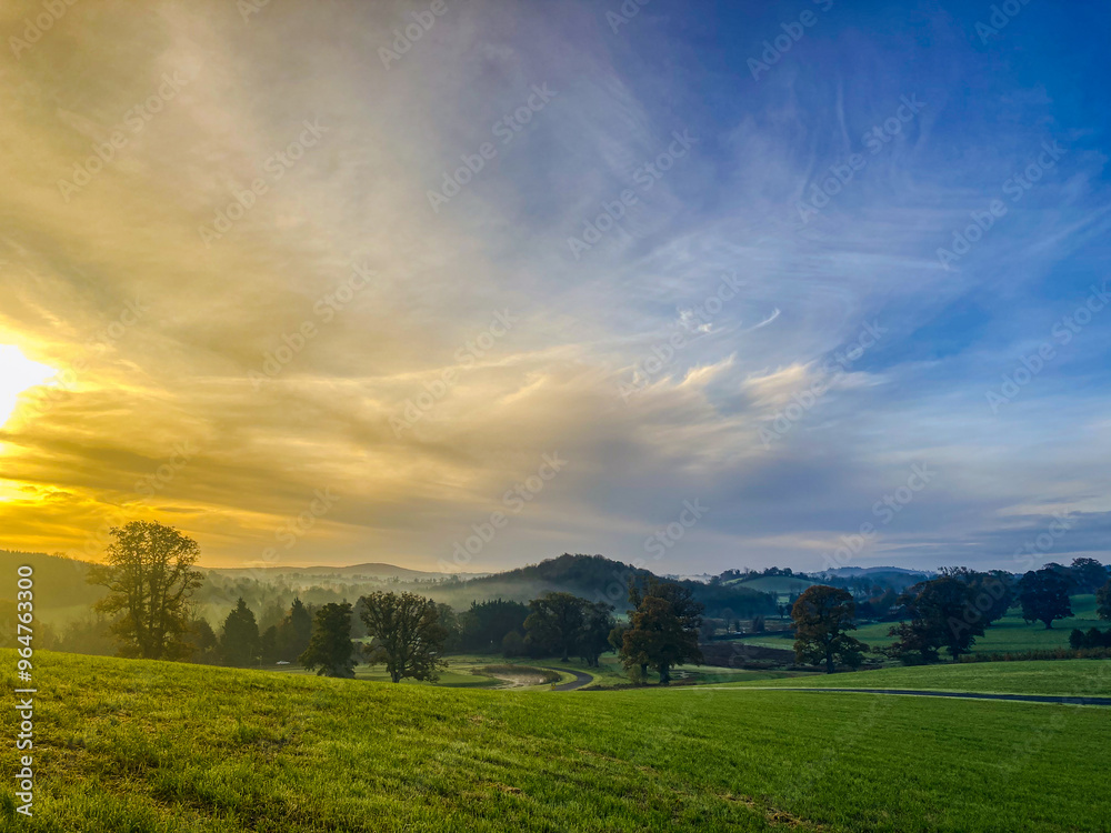 Obraz premium Sunrise Over Misty Rolling Hills at Farnham Estate, County Cavan, Ireland
