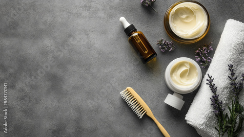 Natural body and hair care products. A photo shows a moisturizing cream, essential oil, comb, and soft towel on a gray background.