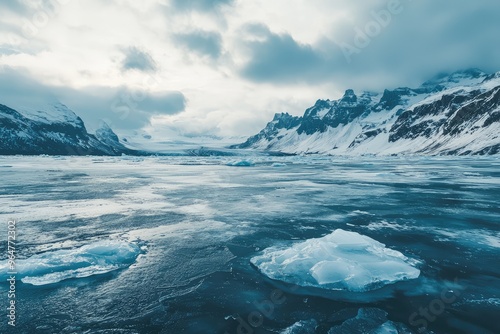 A Frozen Lake Nestled in the Shadow of Majestic Mountains, Icebergs Drifting Calmly.