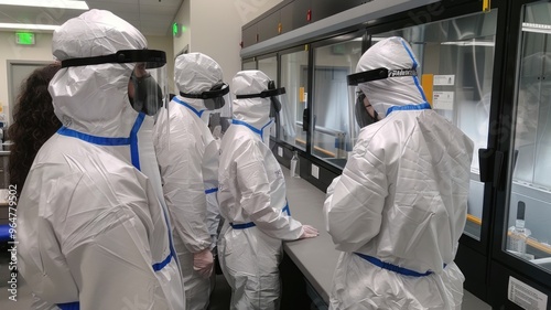 Team of Scientists in Full PPE Conducting Lab Work