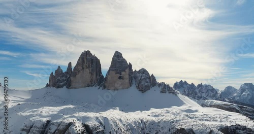 Aerial panoramic shot of the side of the 3 pinnacles (Tre Cime di Lavaredo) in the Dolomites during winter, drone shot, extrem long shot, view from Monte Piana