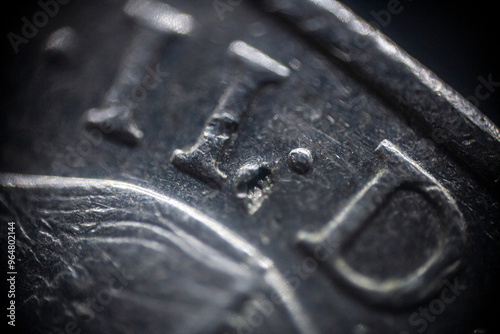 Texture of a damaged coin with engraved inscriptions in macro 