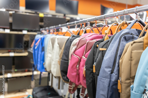 A rack of backpacks and a few TVs are on display