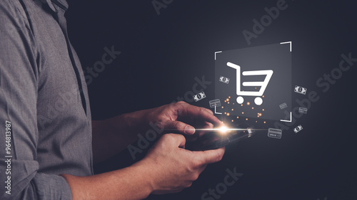 Man is holding smartphone for online shopping with cart icon on virtual screen and using cash, credit, debit card for payment. Concept of online shopping, e-commerce.