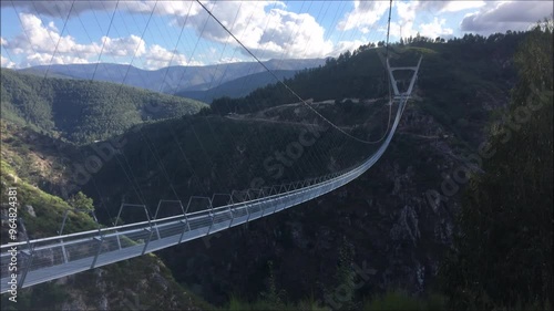 Pedestrian bridge suspended in a mountain valley in northern Portugal