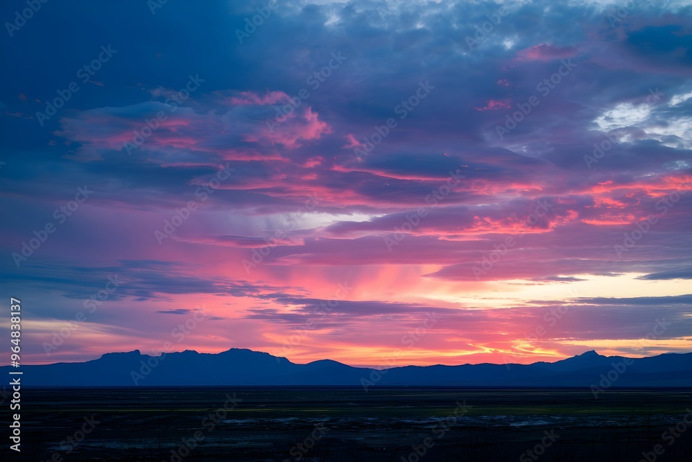 Sunset over plain, colors transitioning, distant mountains silhouette, warm glow Sunset over plain, colors transitioning, distant mountains silhouette, warm glow