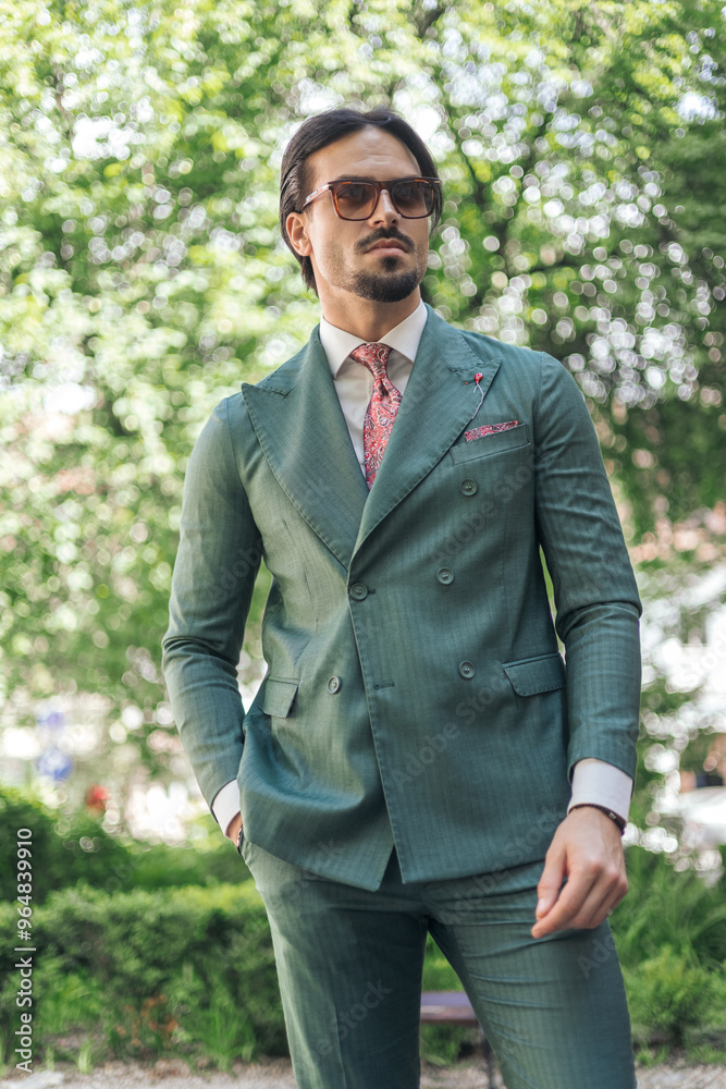 confident young businessman in green suit with sunglasses posing confident young businessman in green suit with sunglasses posing