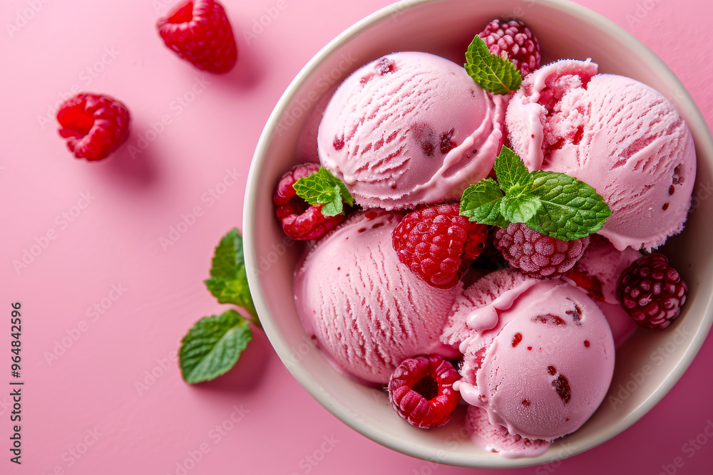 Creamy raspberry ice cream scoops topped with fresh berries and mint leaves create delightful treat. Creamy raspberry ice cream scoops topped with fresh berries and mint leaves create delightful treat.